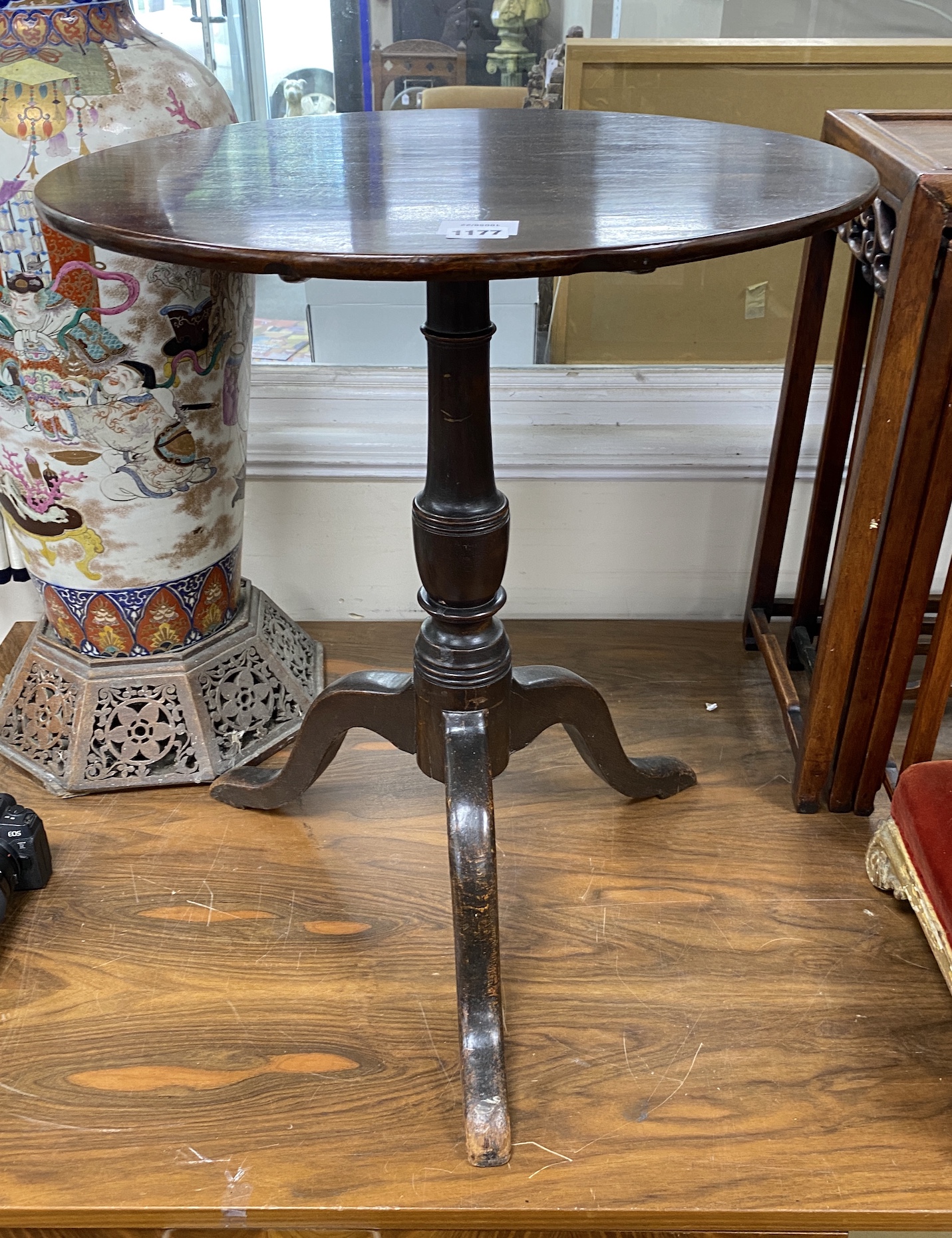 A George III circular mahogany tilt top tripod tea table, diameter 54cm, height 65cm